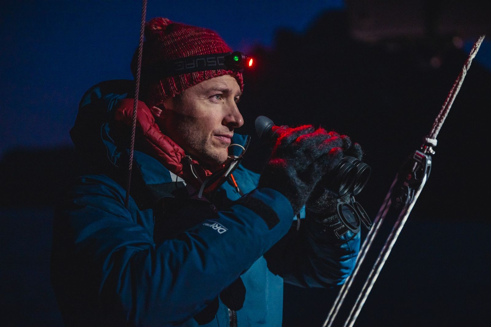 Sailor on night watch wearing an Exposure head torch in red mode