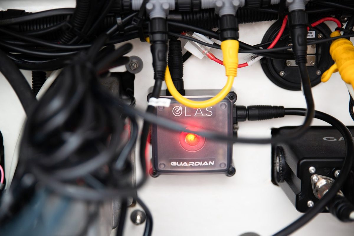 OLAS Guardian unit fitted behind a helm console with its wiring